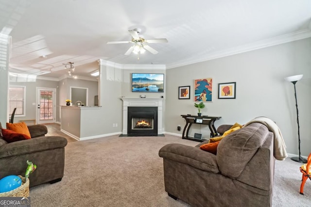 carpeted living room featuring crown molding and ceiling fan