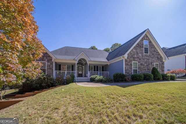 view of front of home with a front yard and a porch