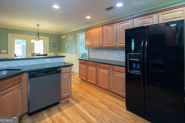 kitchen featuring a notable chandelier, dishwasher, black fridge, and crown molding