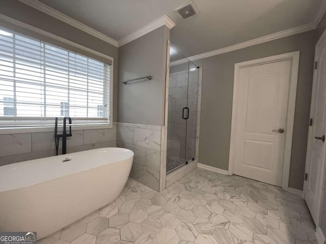 bathroom with crown molding and independent shower and bath