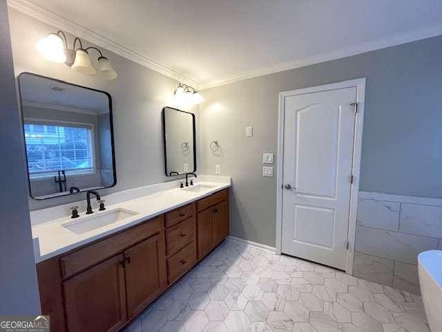 bathroom featuring vanity, tile patterned floors, a bathtub, and crown molding