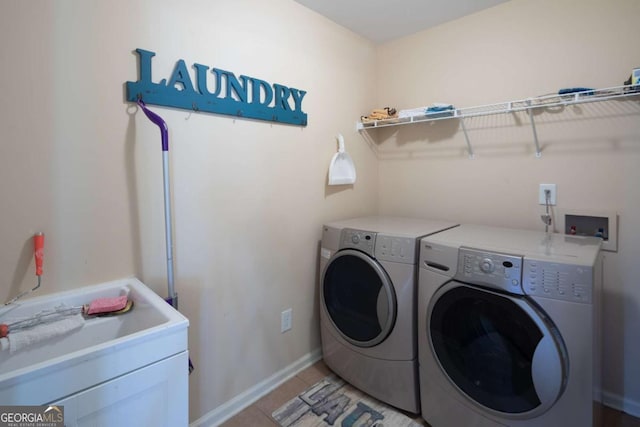 laundry room with light tile patterned floors and washing machine and dryer