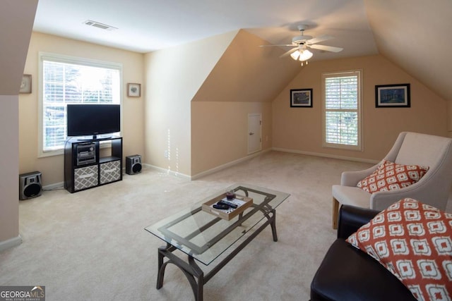 living room featuring light colored carpet, vaulted ceiling, and ceiling fan