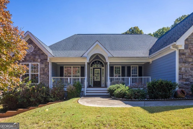 view of front of home with covered porch and a front yard