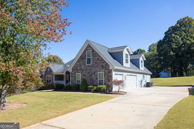 new england style home with a front yard, central AC, a garage, and a storage shed