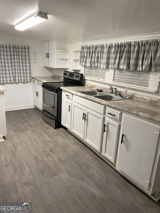 kitchen featuring white cabinetry, stainless steel electric range oven, sink, and dark wood-type flooring