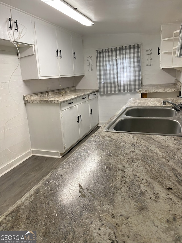 kitchen featuring sink, white cabinets, and dark hardwood / wood-style floors