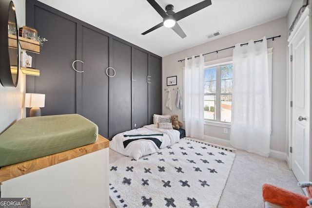 bedroom featuring a closet, ceiling fan, and light colored carpet