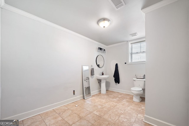 bathroom with sink, toilet, crown molding, and tile patterned floors