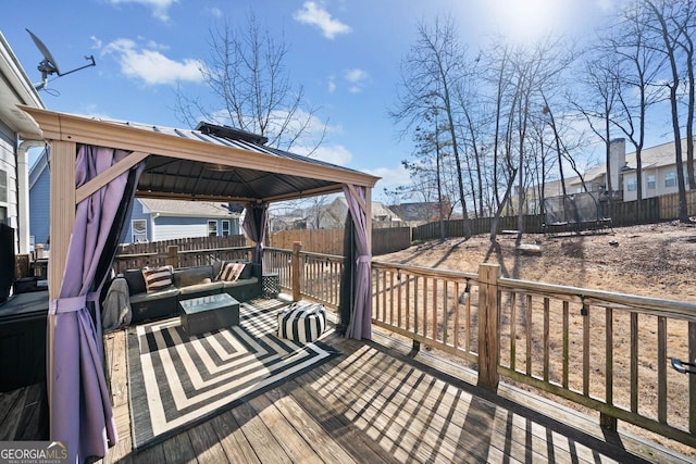 wooden deck with a gazebo, a trampoline, and an outdoor hangout area