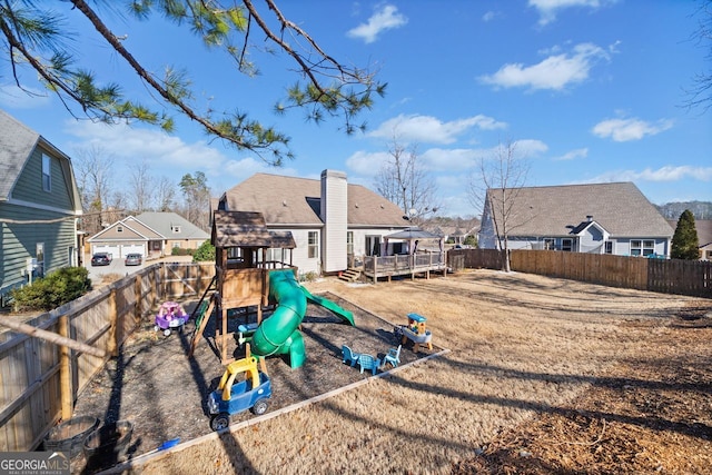 back of property featuring a gazebo, a playground, and a wooden deck