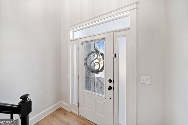 entryway with light hardwood / wood-style floors and a healthy amount of sunlight