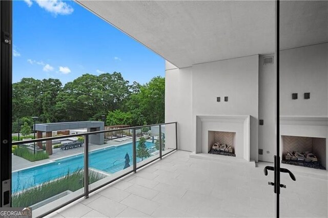 balcony featuring exterior fireplace