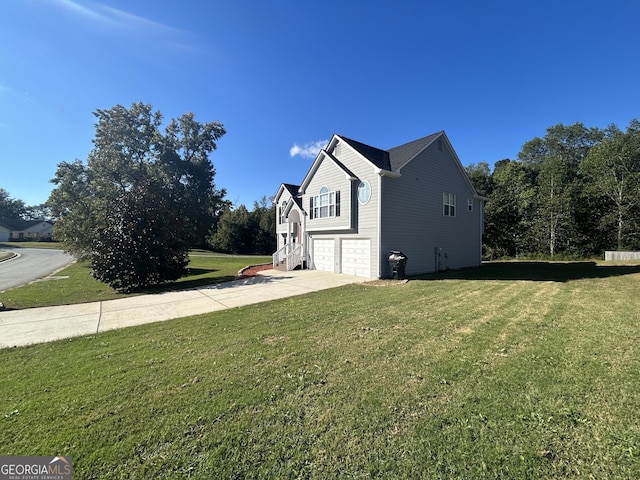 view of side of home with a garage and a yard