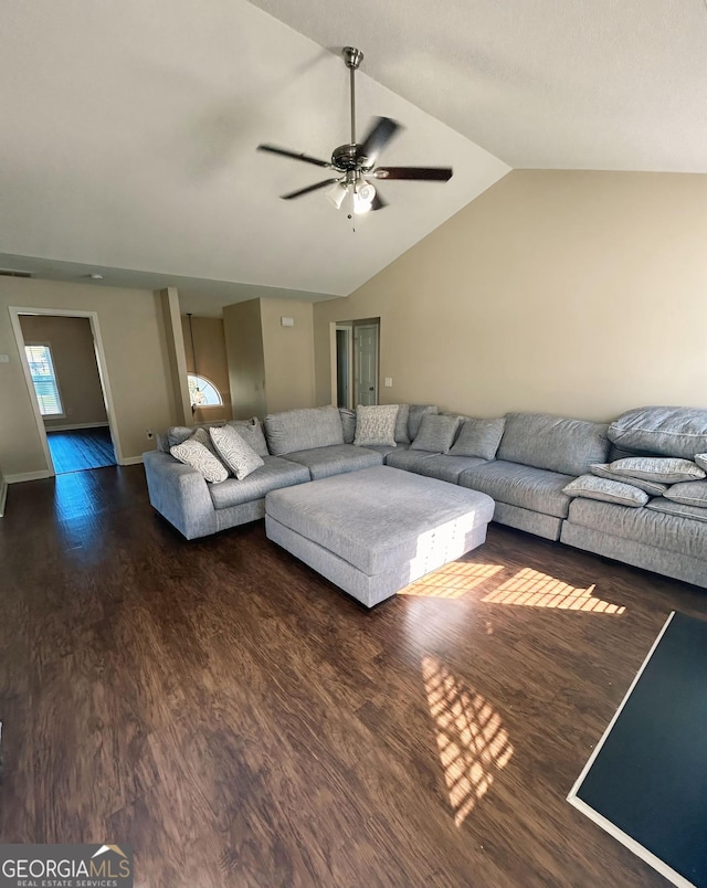 unfurnished living room featuring ceiling fan, dark wood-type flooring, and vaulted ceiling