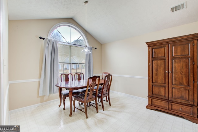 dining room featuring vaulted ceiling