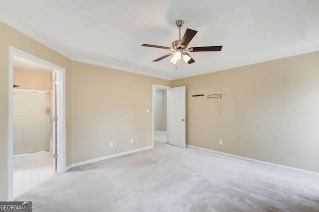 unfurnished bedroom with a closet, ceiling fan, a spacious closet, and crown molding