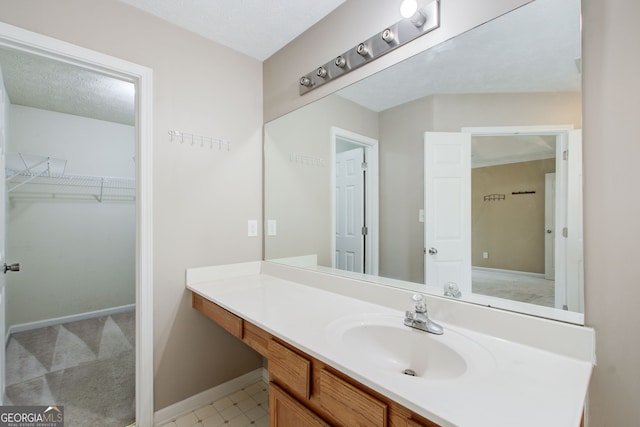 bathroom with a textured ceiling and vanity