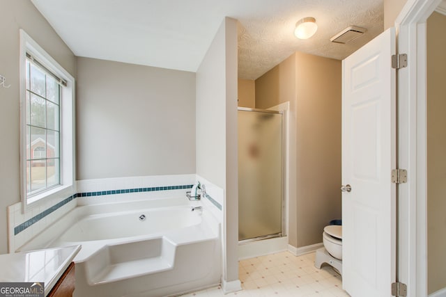 bathroom with a textured ceiling, toilet, and shower with separate bathtub