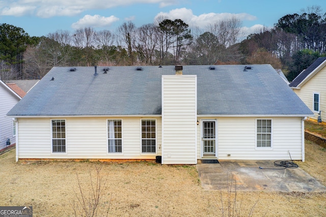 rear view of house featuring a patio and a yard