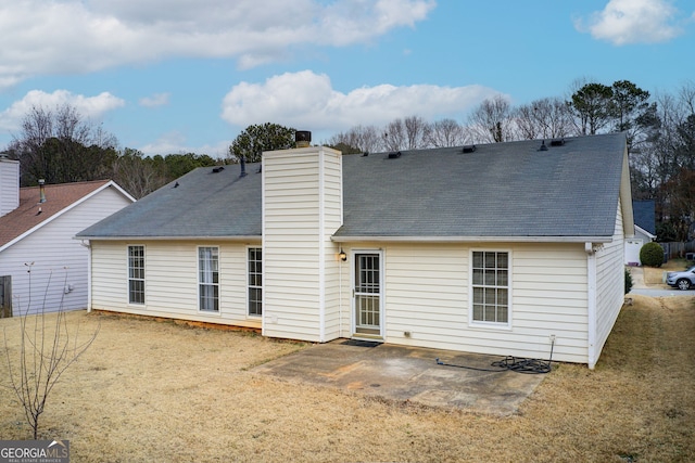 back of house with a patio area and a yard