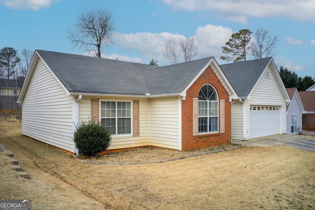 view of front of property featuring a garage and a front yard