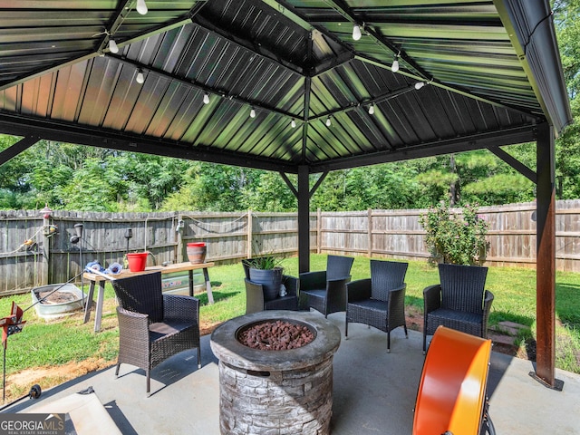 view of patio featuring a gazebo and an outdoor fire pit