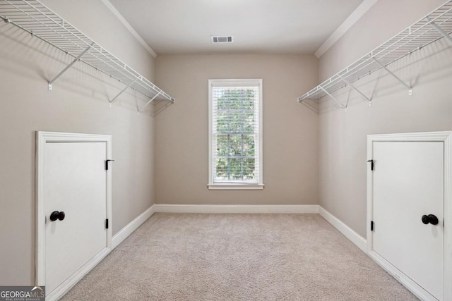 clothes washing area with light colored carpet