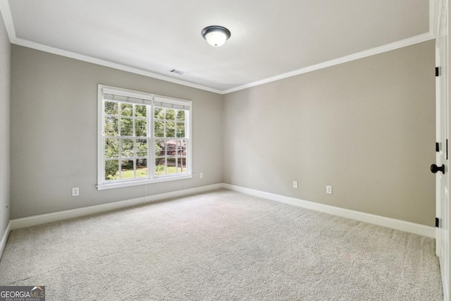 carpeted spare room featuring ornamental molding