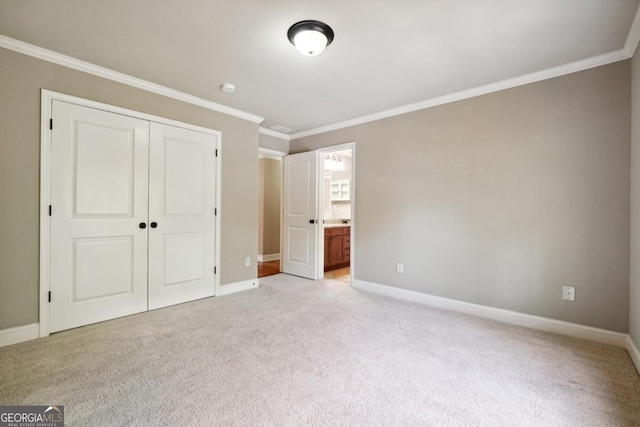 unfurnished bedroom with ornamental molding, light carpet, and a closet