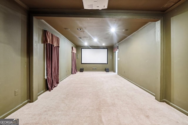 carpeted home theater featuring ornamental molding