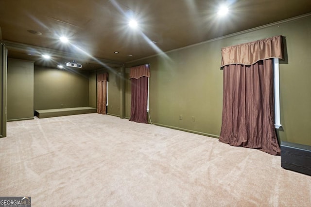 empty room featuring carpet flooring and crown molding