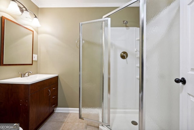 bathroom featuring vanity, tile patterned floors, a shower with shower door, and crown molding