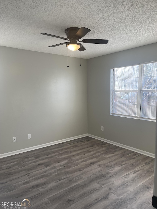 unfurnished room with dark hardwood / wood-style floors, ceiling fan, and a textured ceiling