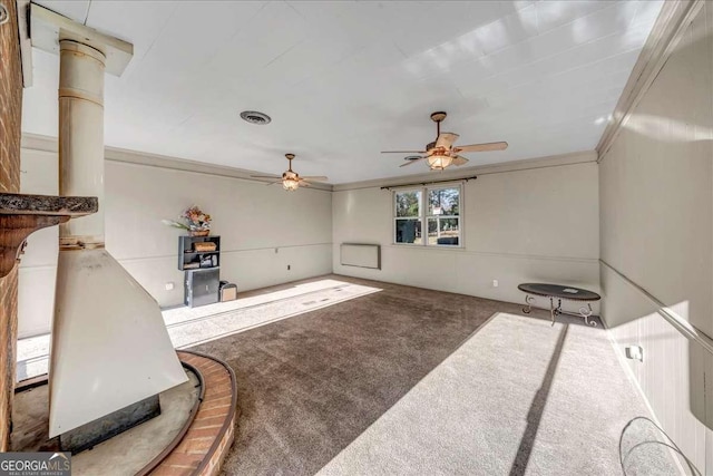 living room featuring ceiling fan, ornamental molding, and carpet floors