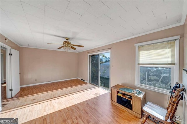 interior space with ceiling fan, ornamental molding, and light hardwood / wood-style flooring