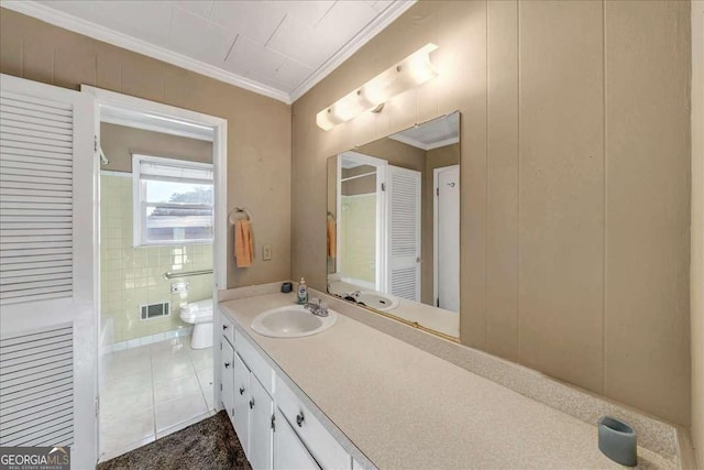 bathroom with tile patterned floors, vanity, ornamental molding, and toilet