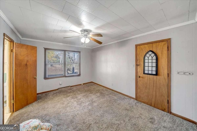 unfurnished bedroom featuring carpet, ceiling fan, ornamental molding, and a baseboard heating unit