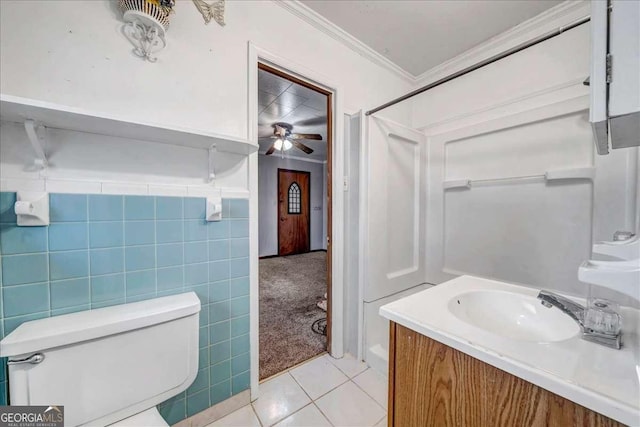 bathroom featuring tile patterned floors, tile walls, ornamental molding, and ceiling fan