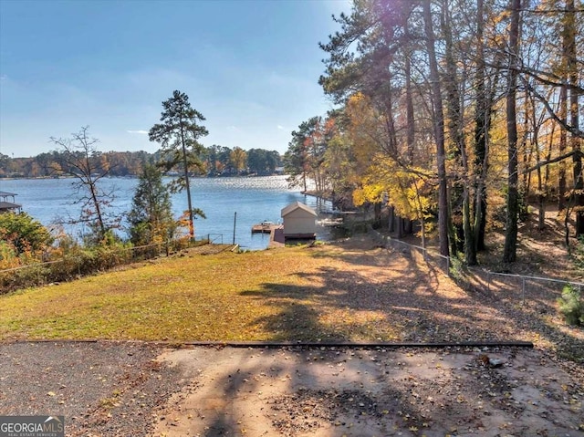 view of yard featuring a dock and a water view