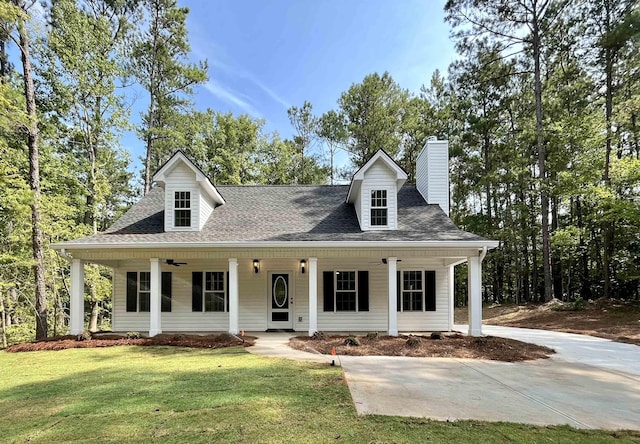 cape cod home featuring a front lawn and a porch