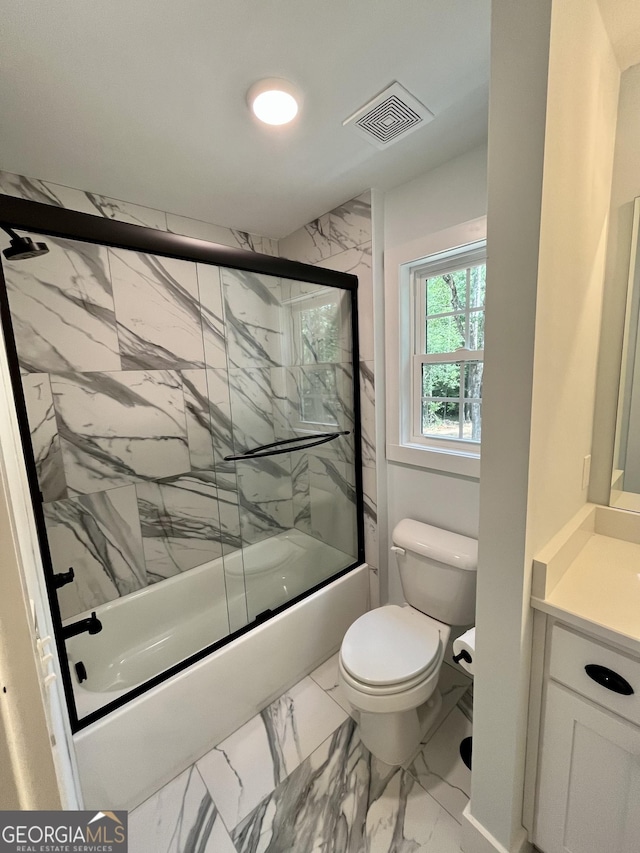 full bathroom featuring combined bath / shower with glass door, vanity, and toilet