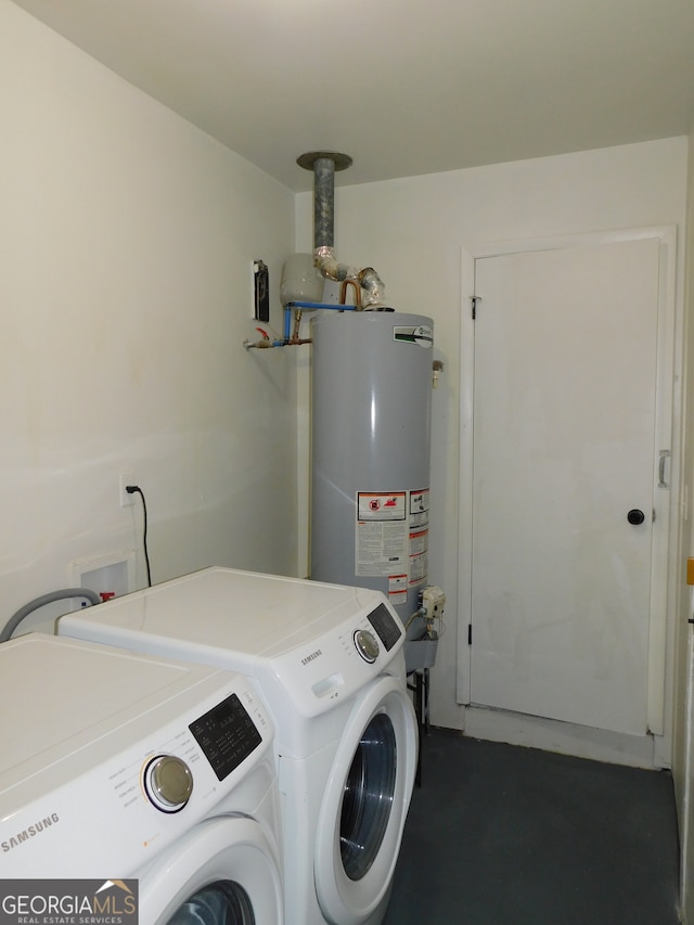 clothes washing area featuring laundry area, separate washer and dryer, and gas water heater