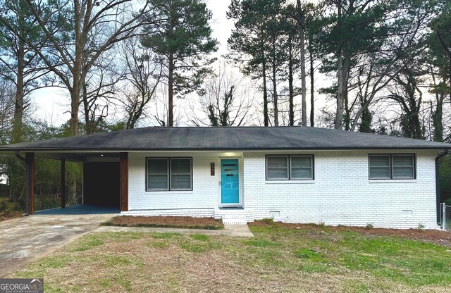 single story home with a carport and a front lawn