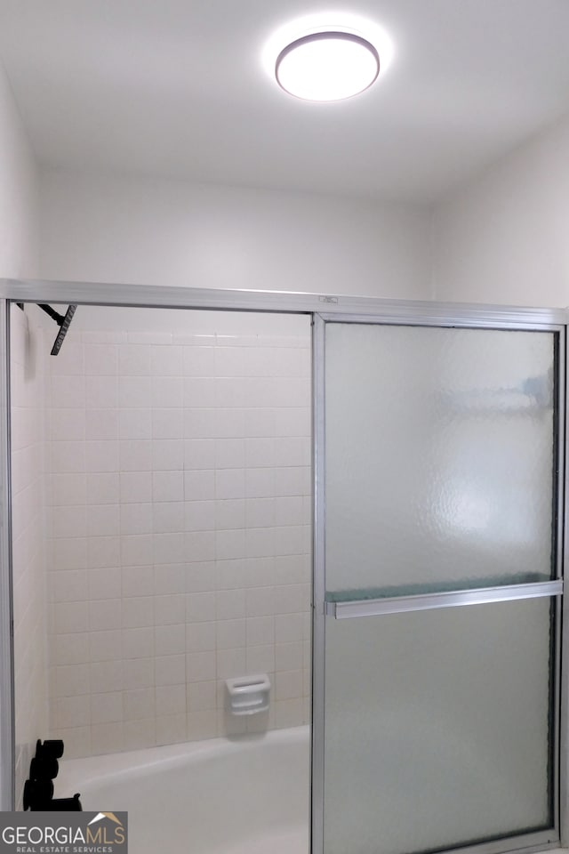 full bathroom with shower / bath combination with glass door