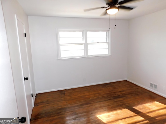 unfurnished room with a ceiling fan, baseboards, visible vents, and wood finished floors