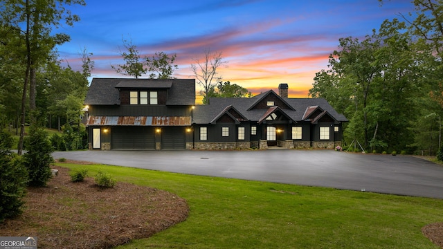 view of front of home featuring a lawn and a garage