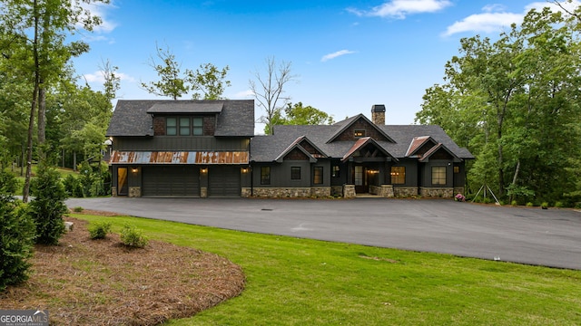 view of front of house with a front yard and a garage