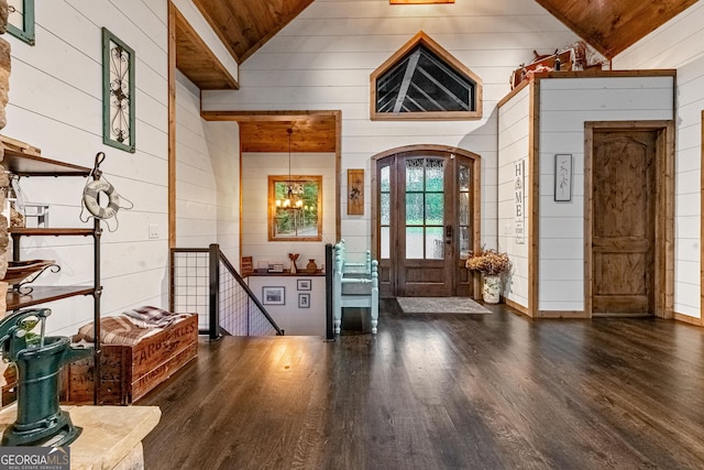 foyer entrance with wood walls and wooden ceiling