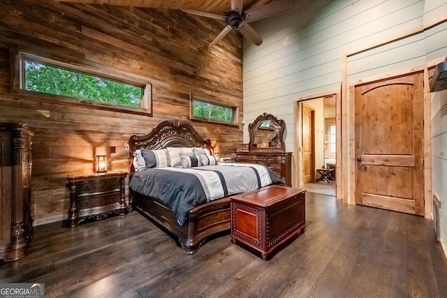 bedroom with dark wood-type flooring, ceiling fan, wooden walls, and wood ceiling